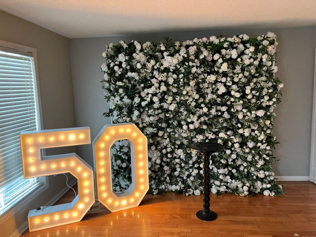 Fergus marquee numbers and a flower wall 