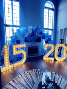 Innisfil marquee numbers that spell 15 and 20. Framed by a balloon arch in Innisfil