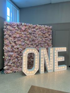 Rent Orangeville marquee letters backed by a flower wall. 