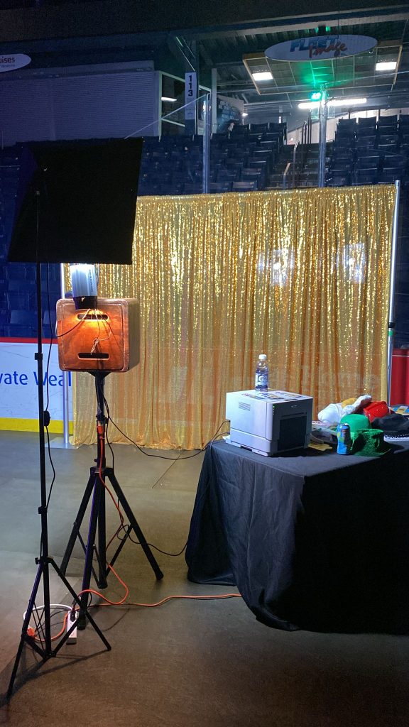 Photo booth in Midland with a gold photo booth backdrop